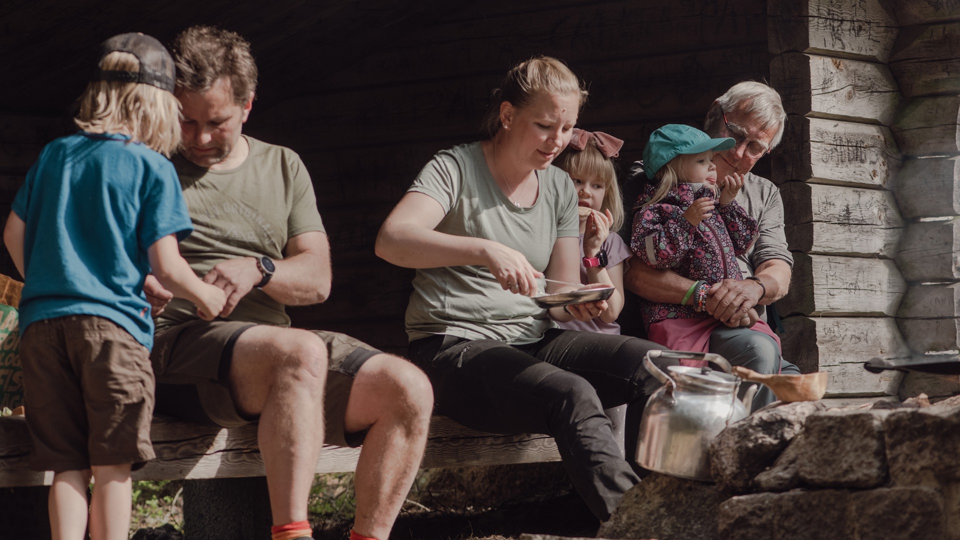 En familj sitter i vindskyddet i Högaliden.