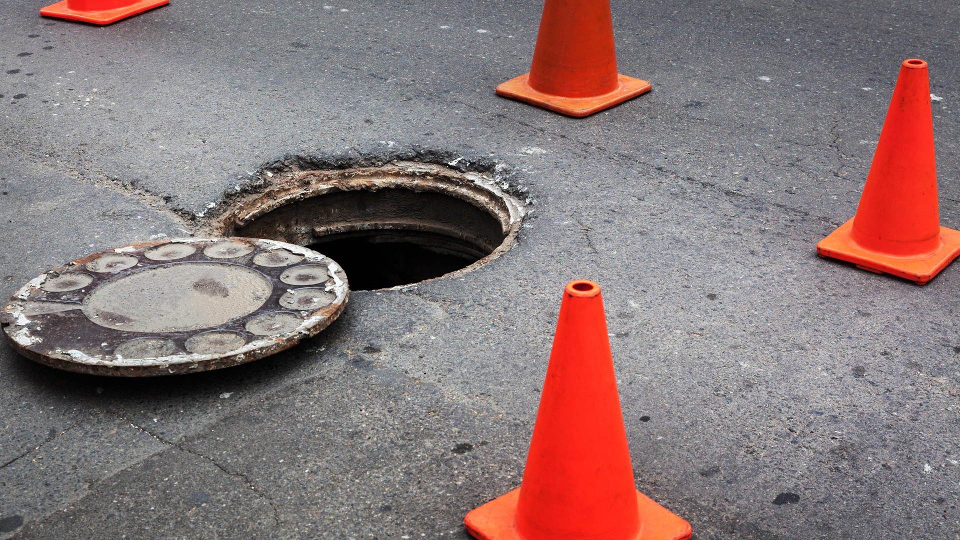 Ett hål i gatan och vägkoner utplacerade runt omkring.