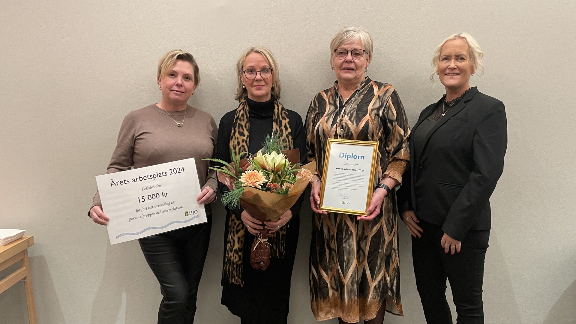 Personal från årets arbetsplats lokalvården visar upp diplom och blommor.