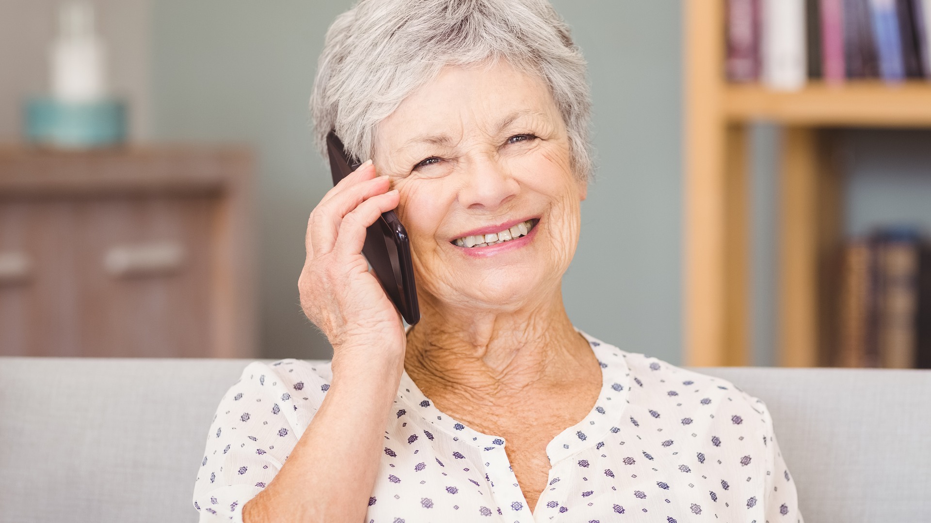 Portrait of senior woman using mobile phone at home